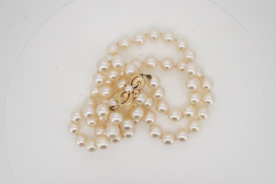 A single strand cultured pearl necklace by Mikimoto, with signed 14k and cultured pearl set clasp, 50cm. Condition - good